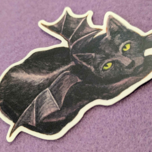 S40 A black cat with bat wings crouches, ready to cuddle